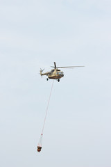Russian military helicopter MI-8 extinguishes fire with water