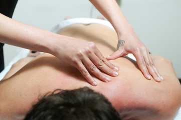 Young man enjoying massage at spa