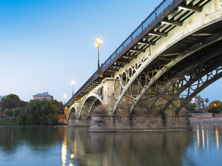 Fototapeta na wymiar Triana Bridge, the oldest bridge of Seville at twilight