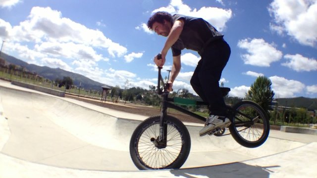 BMX bike stunt in skateboard park