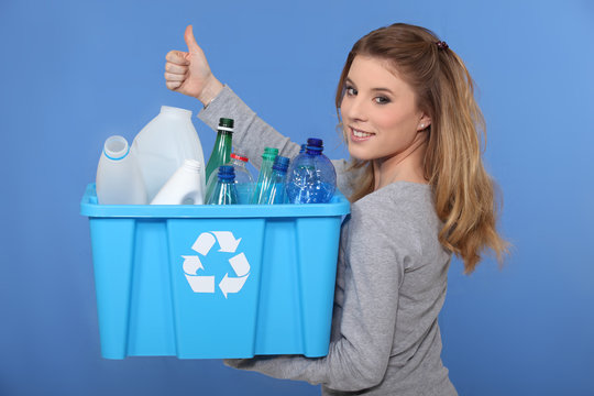 Woman recycling empty bottles