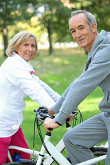 Naklejka premium Senior couple on a bicycle