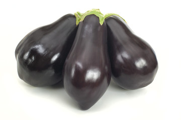 Family of three ripe aubergines