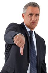 Disapproving businessman giving the thumb's down