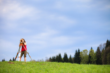 Young female land surveyor at work