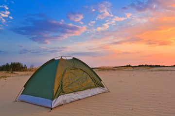 small touristic tent in a desert at the evening