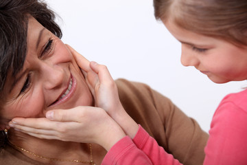 Daughter touching mother's face