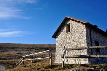 mountain hut with grass and blue sky