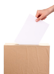 Hand with voting ballot and box isolated on white