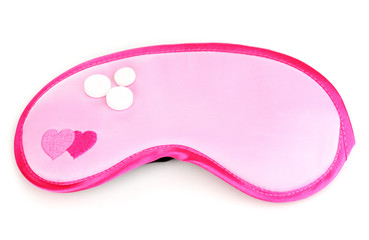 Sleeping mask and tablets isolated on white
