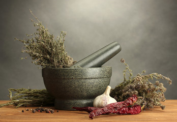 dried herbs in mortar and vegetables,