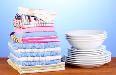 kitchen towels with dishes on blue background close-up