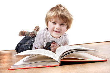 young 4 year old boy reading a book