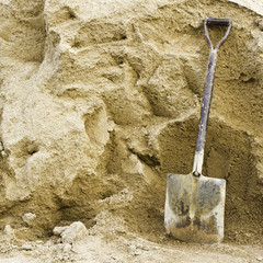 Shovel sand for construction.,A shovel in a sand