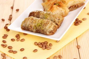 Sweet baklava on plate on wooden background