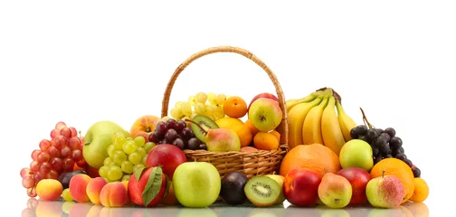 Wandaufkleber Assortment of exotic fruits in basket isolated on white © Africa Studio