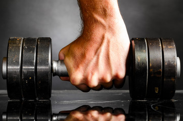 male hand is holding metal barbell - 44363740