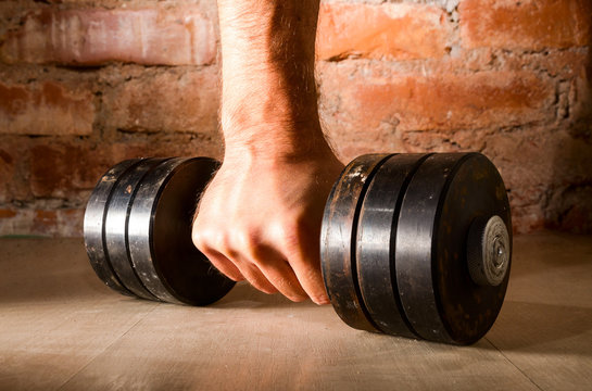 Male Hand Is Holding Metal Barbell