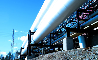 industrial pipelines with insulation against natural blue backgr