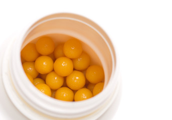 Yellow pills in open bottle
