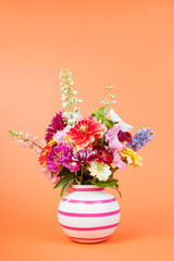 Colorful garden bouquet on orange background