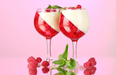 fruit jelly with berries in glasses on pink background