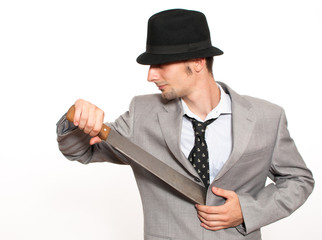 Young businessman holding a machete
