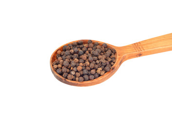 Black pepper granules in wooden spoon, isolated on white