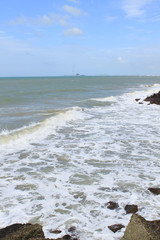 peaceful white sand beach with rocky surf protection in Thailand