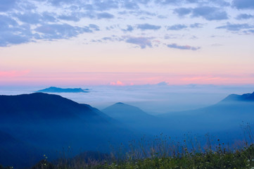 Clouds and fog at sunrise in the mountains