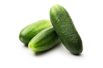 Fresh green cucumbers on white