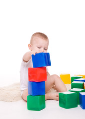 Baby boy plays with toy blocks