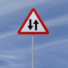 Two way road sign on a blue sky background