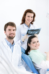 Dentist, assistant and client are satisfied of their work