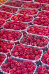 Organic raspberrys on market stand