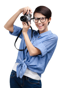 Beautiful girl in spectacles hands retro camera, isolated