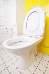 Modern toilet with tiled walls and floor, seat up