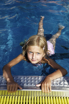 Blond girl swimming in pool