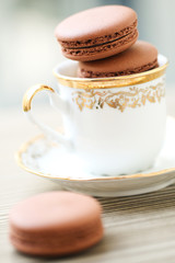 Chocolate macarons in tea cup