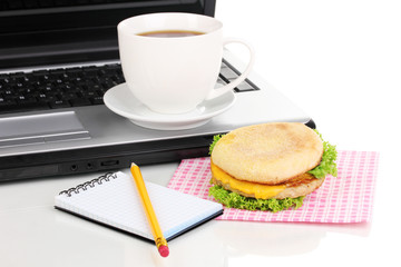 Eating at work place near laptop
