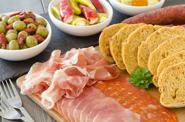 Tapas - Lomo, chorizo, serrano ham, chilies & olives, with bread