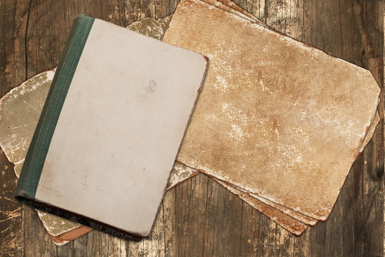 Vintage book and papers on a wooden background