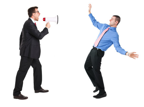 Angry businessman yelling via megaphone to a man