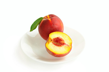 Single fresh ripe peach on the dish