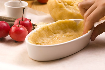 Detail of child hands making apple pie