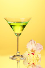 glass with cocktail and gladiolus bud