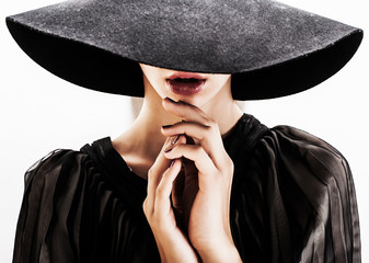 girl in black hat touching face and lips - 44400945