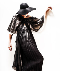 girl in black hat touching face and lips