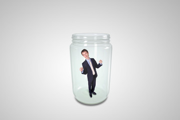 Businessman inside glass jar
