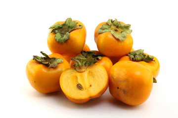 Half of persimmon fruits for health on white background